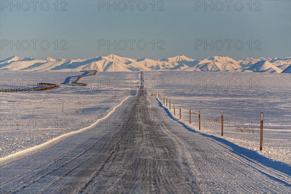 Icy gravel road in winter, Dalton Highway, Trans Alaska Pipeline, Brooks Range, Alaska, USA, North