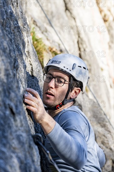 Sport climbing with rope, climber on a rock face, Frauenwasserl climbing garden, Ammergau Alps,