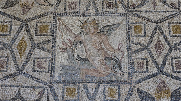 Eros riding a dolphinAncient mosaic depicting a winged man, with geometric patterns and