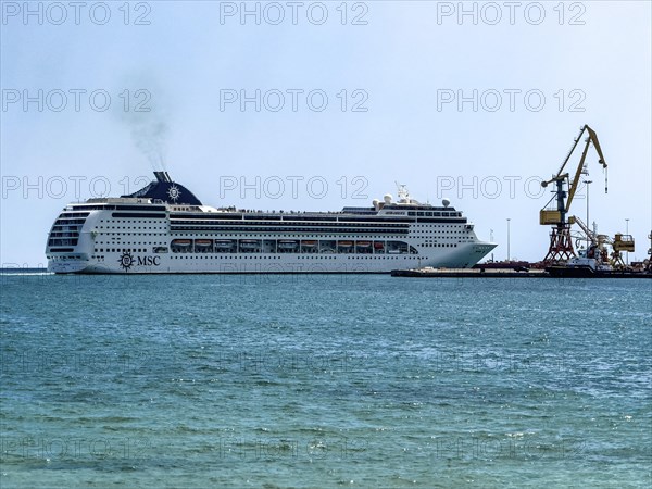 Huge cruise ship from shipping company MSC arrives in Iraklion harbour emitting plume of exhaust