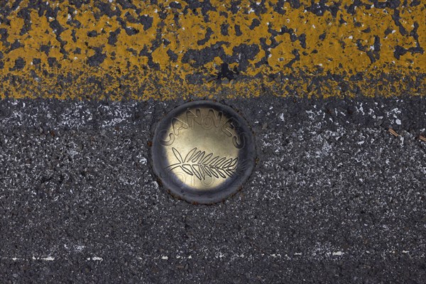 Cannes, France, 14 May 2024: Floor marker with Cannes logo during the opening of the 77th Cannes