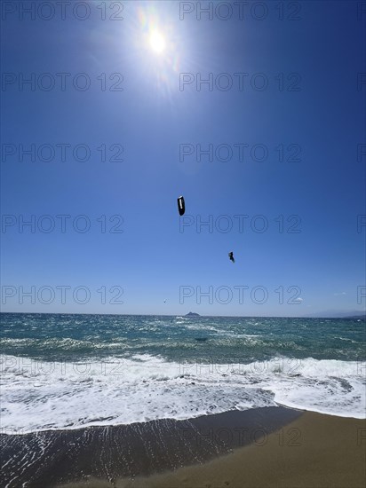 Kitesurfer Kitesurfer takes off in strong wind and waves rough sea moving sea flies with inflated