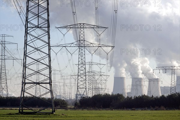 Steam rises from the cooling towers of the Vattenfall power plant in Jaenschwalde, power lines and