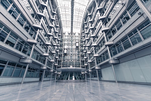 Wide-angle shot of a modern office building with glass facades and symmetrical structure, Berlin,