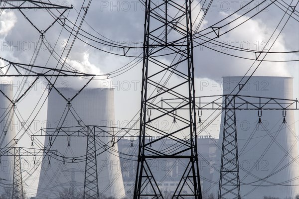 Steam rises from the cooling towers of the Vattenfall power plant in Jaenschwalde, power lines and