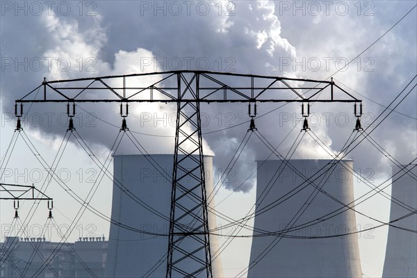 Steam rises from the cooling towers of the Vattenfall power plant in Jaenschwalde, power lines and