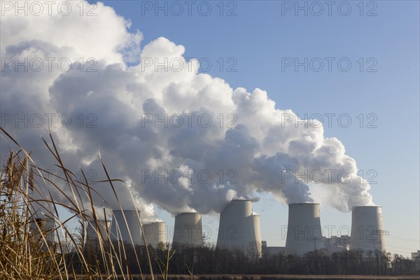 Steam rises from the cooling towers of the Vattenfall power plant in Jaenschwalde, power lines and