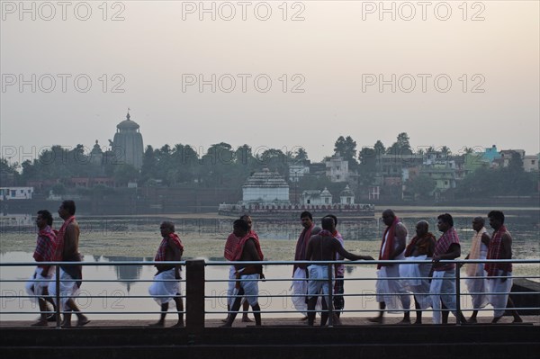High caste hindus are walking along the lake Bindu, brahmins have performed a hindu ritual,