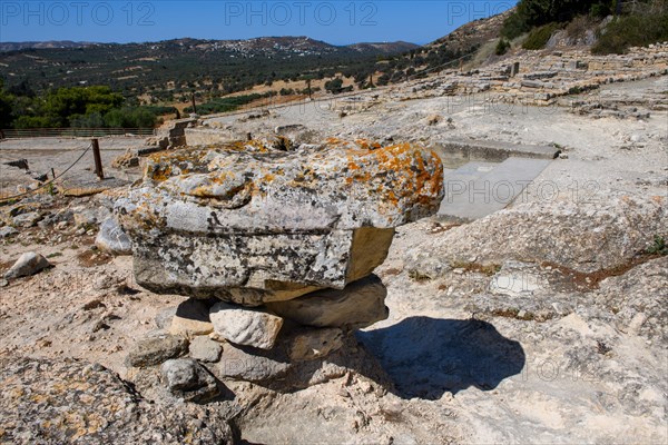 Stone fragment column fragment remains of palace on hill of Phaistos excavation site of Minoan