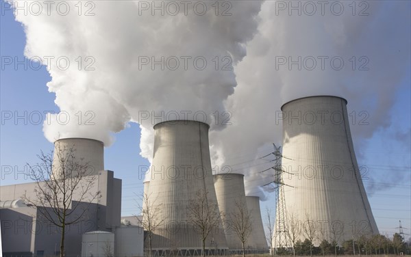 Steam rises from the cooling towers of the Vattenfall power plant in Jaenschwalde, power lines and
