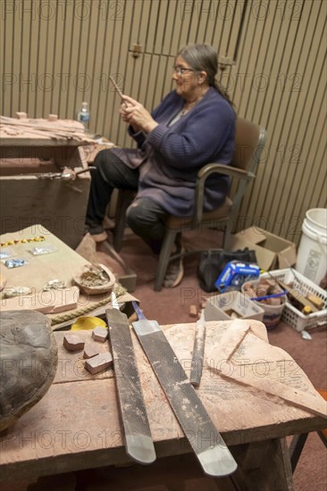 Pipestone, Minnesota, A Native American uses files in making pipes from pipestone at Pipestone