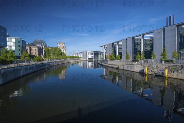 Reichstag, Paul-Loebe-Haus and Marie-Elisabeth-Lueders-Haus reflected in the Spree at sunrise,
