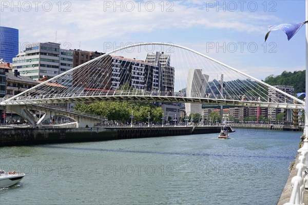 Pedestrian bridge Zubizuri, White bridge, Bilbao, Modern bridge over a river Nervion, with