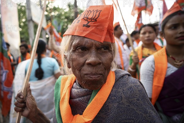 Bharatiya Janata Party (BJP) supporters arrives to to see a roadshow of Union Home minister Amit