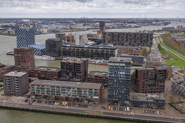 Modern residential complexes and buildings line the riverbank, shaping the urban architecture under