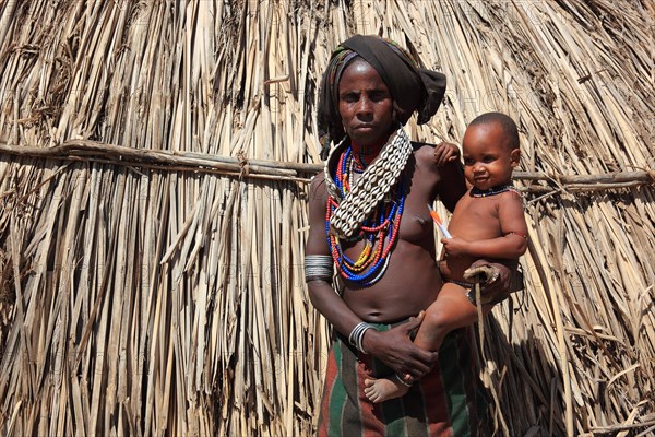 South Ethiopia, in a village of the Arbore or Erbore people at Lake Stefano, young woman with baby