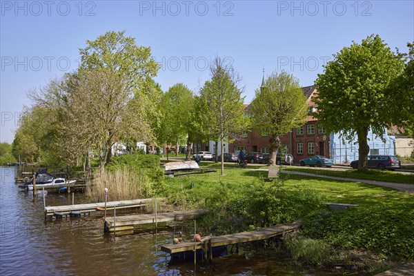Jetties for pleasure craft on the banks of the Westersielzug in Friedrichstadt, Nordfriesland