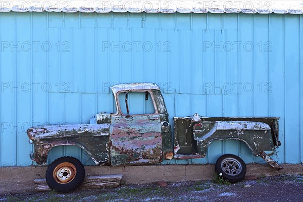Side view of an antique pick-up truck hanging cut open on the wall, Route 66, Seligman, Arizona