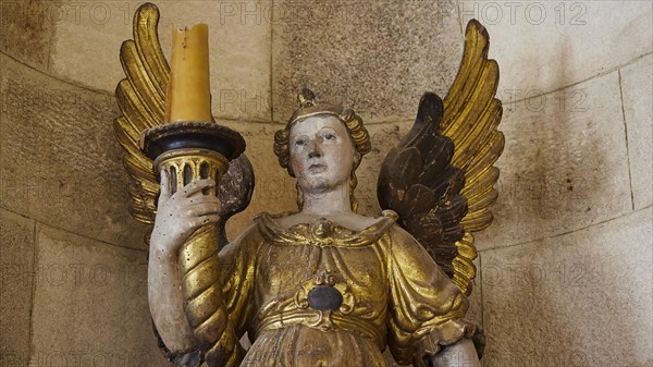 Golden angel sculpture with candle in historical ambience, interior view, Grand Master's Palace,