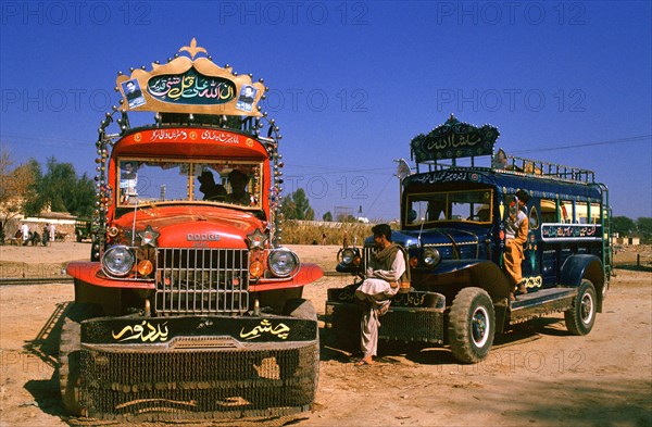 Colourful buses, bus drivers and helpers waiting for passengers, Punjab province, Pakistan, Asia