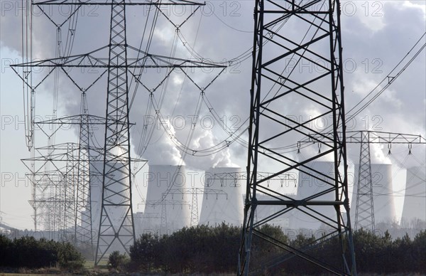 Steam rises from the cooling towers of the Vattenfall power plant in Jaenschwalde, power lines and