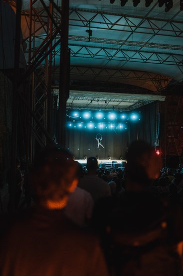 Acrobatic stage performance with audience in the foreground. Ehrenbreitstein Fortress, Koblenz