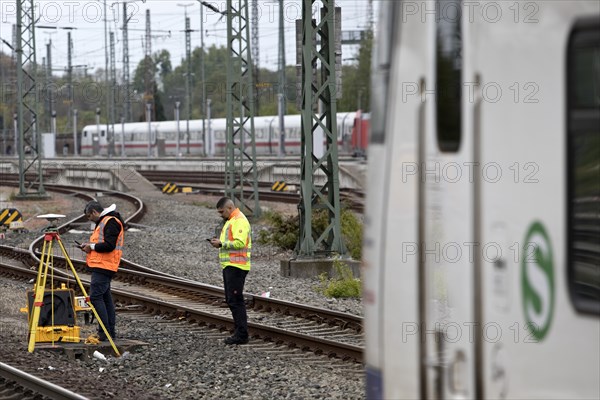 Railway worker surveying on the tracks with S-Bahn, Hanover-Nordstadt station, Hanover, Lower
