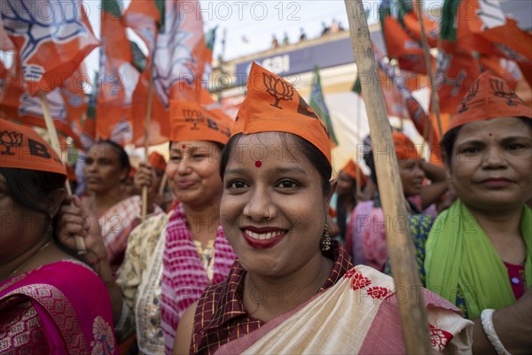 Bharatiya Janata Party (BJP) supporters arrives to to see a roadshow of Union Home minister Amit