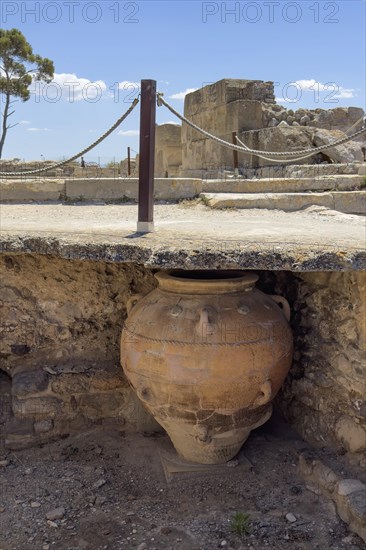 View into historical storeroom below present floor level with large decorated clay vessel Pithoi in