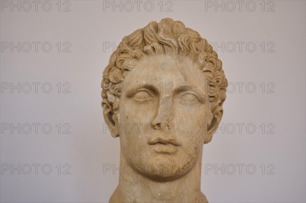 Head of an athleteAncient stone bust of a man in classical style, displayed in a museum, interiors,