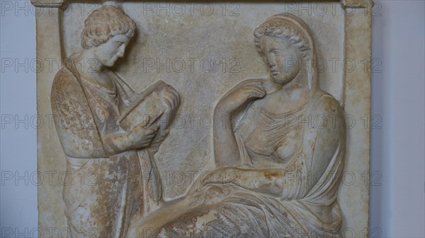 Tomb stele from Kalliarista, Dead seated woman and standing servant, A stone relief shows two