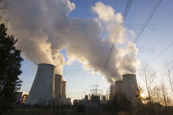 Steam rises from the cooling towers of the Vattenfall power plant in Jaenschwalde, power lines and