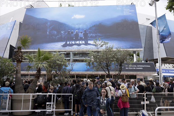 Cannes, France, 14 May 2024: Guests in front of the poster at the opening of the 77th Cannes