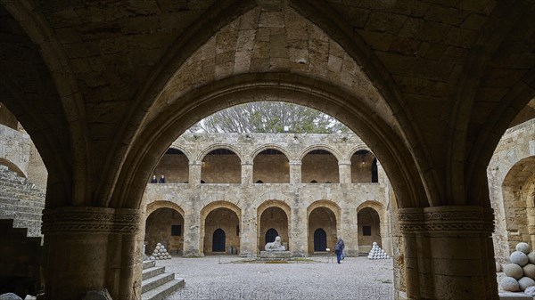 Architecture of a historic courtyard with Gothic arcades, indicates medieval construction, outdoor