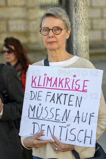 Participant in a silent protest for the hunger strikers. The poster reads: Climate crisis, the