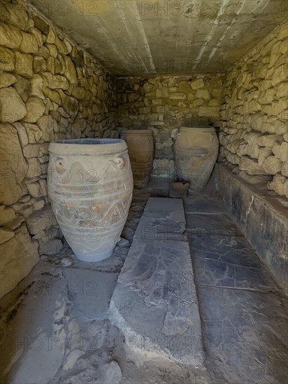 View into historical storeroom below present floor level with three large decorated clay vessels