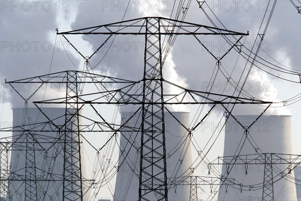 Steam rises from the cooling towers of the Vattenfall power plant in Jaenschwalde, power lines and