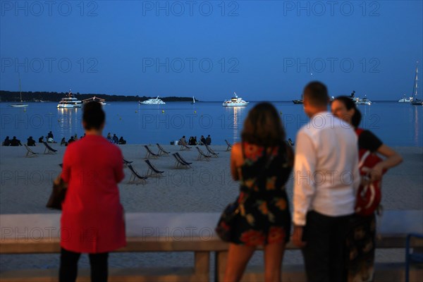 Cannes, France, 13 May 2024: People look out over the Cote d'Azur on the Boulevard de la Croisette