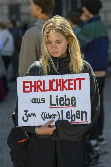 Participant in a silent demonstration for the hunger strikers. Her poster reads Honesty for the