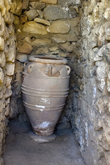 View into historical storeroom below present floor level with large decorated clay vessel Pithoi in