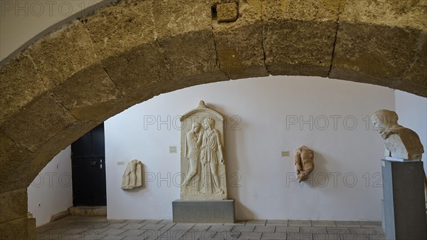 Tomb stele, Krito and Timarista, An exhibition space with ancient stone sculptures and a large