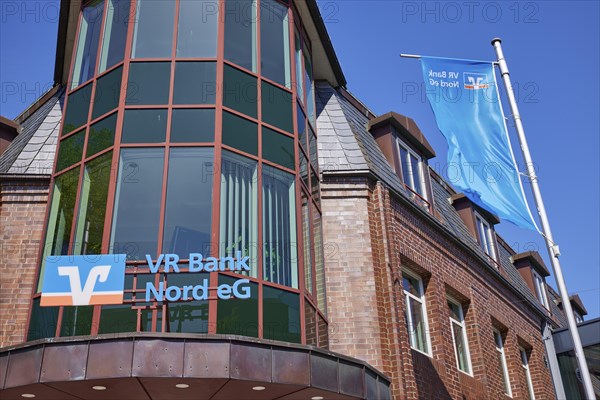 Logo of Volksbank Raiffeisenbank VR Bank Nord eG with flags at the Niebuell branch, Nordfriesland