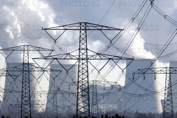 Steam rises from the cooling towers of the Vattenfall power plant in Jaenschwalde, power lines and