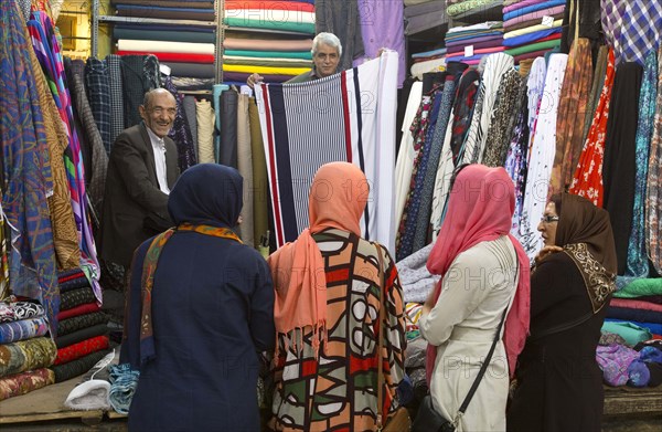 Women buy colourful fabrics at a bazaar in Shiraz on 05.04.2015., Shiras, Iran, Asia