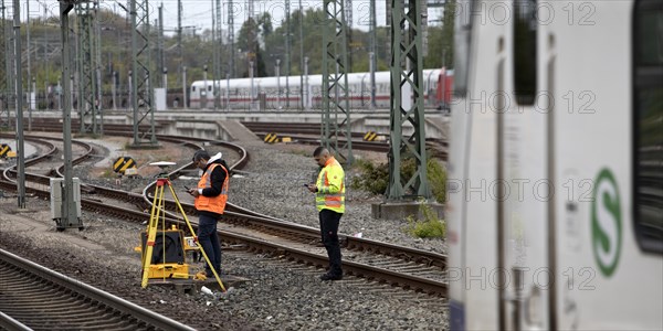 Railway worker surveying on the tracks with S-Bahn, Hanover-Nordstadt station, Hanover, Lower