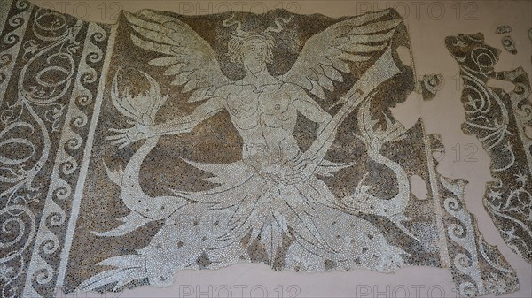 Antique mosaic of a winged creature, sea god Triton, damaged, shows detailed mythological
