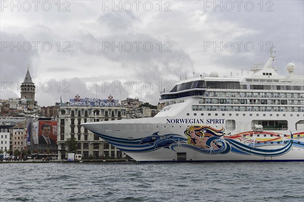Close-up of the cruise ship 'Norwegian Spirit' in front of the silhouette of the Galata Tower,