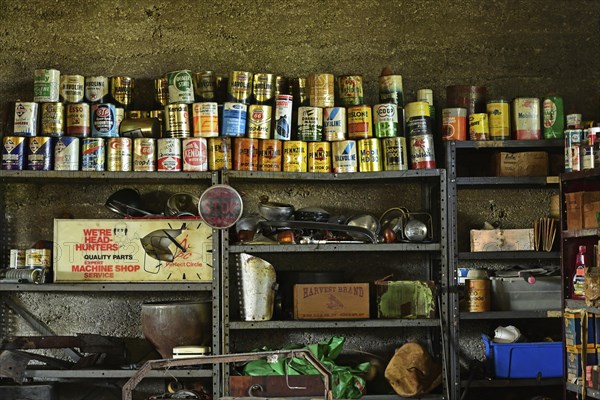 Historic garage on Route 66 with grease and oil cans in the frame, USA, North America