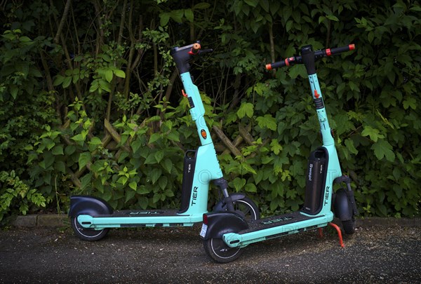 E-scooters parked at the side of the road in the TIER bike hire centre, Stuttgart,