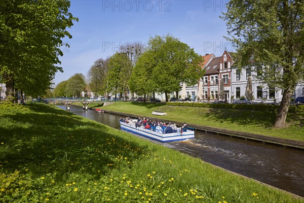 Excursion boat on the Mittelburggraben in Friedrichstadt, North Friesland district,